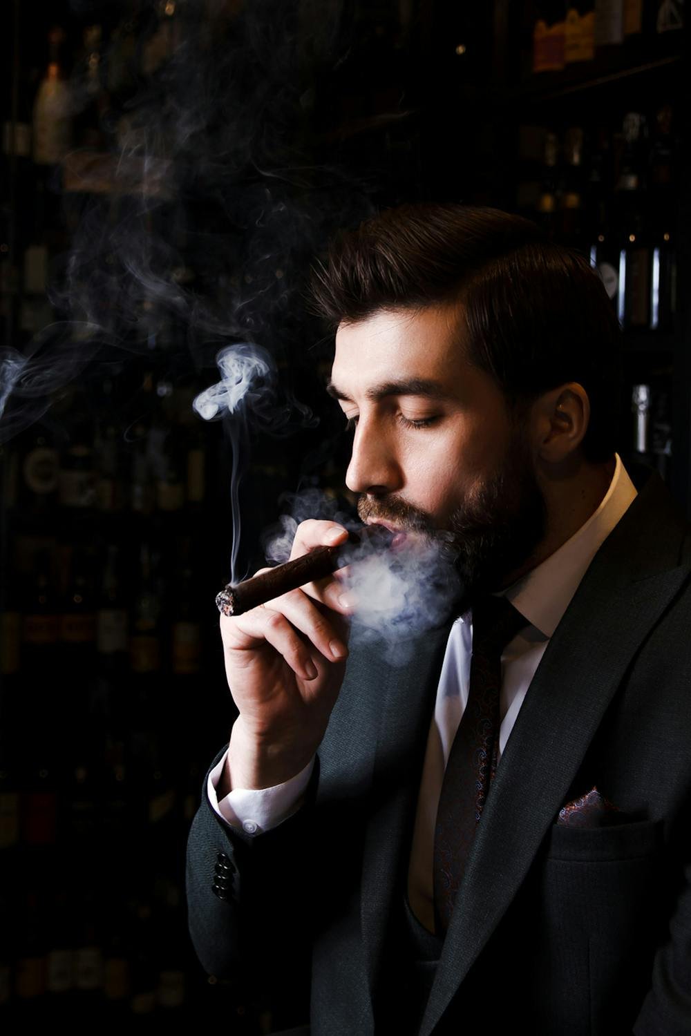 best cigar holders for golf carts - elegant man smoking cigar luxury lifestyle